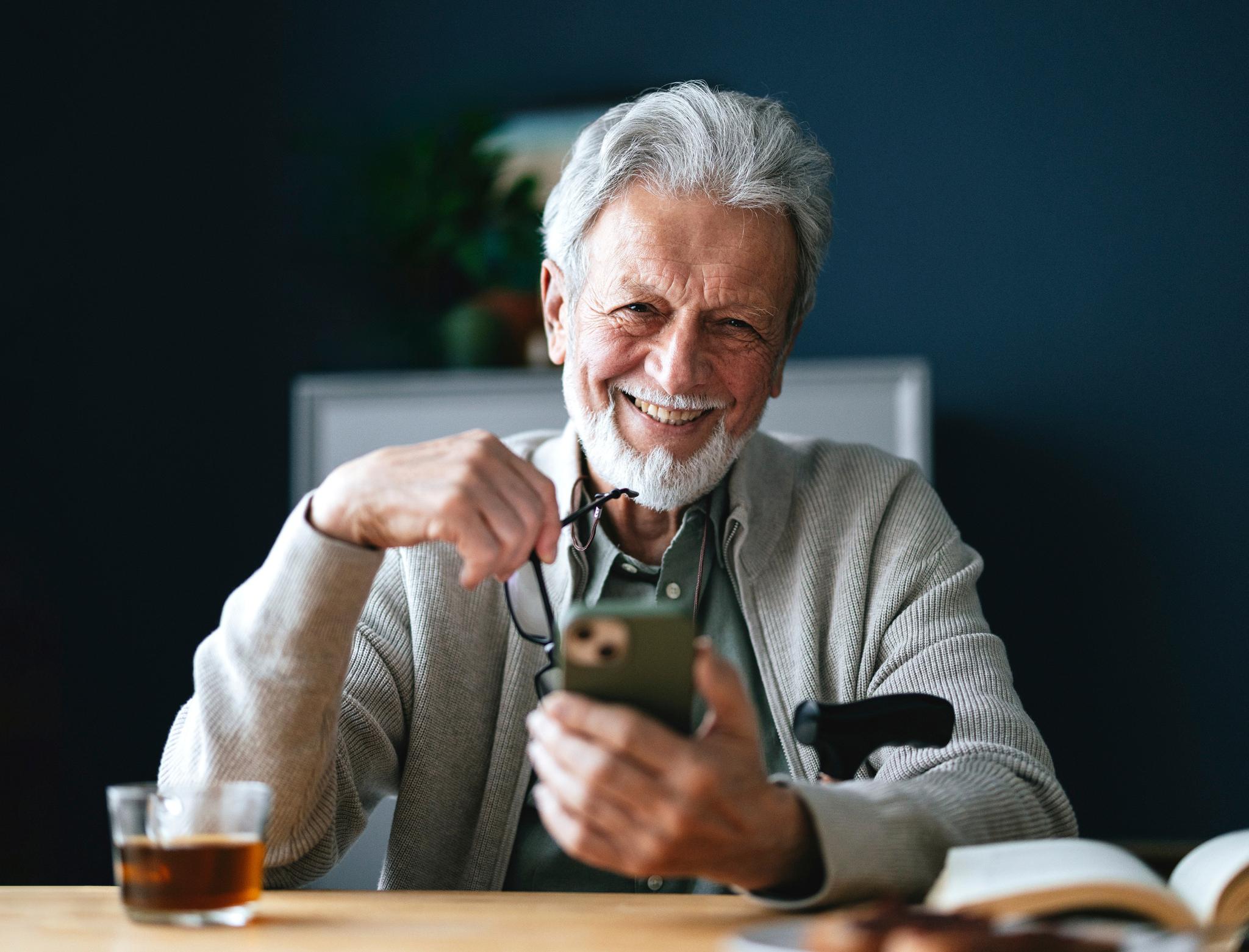 Smiling man looking at his cell phone.